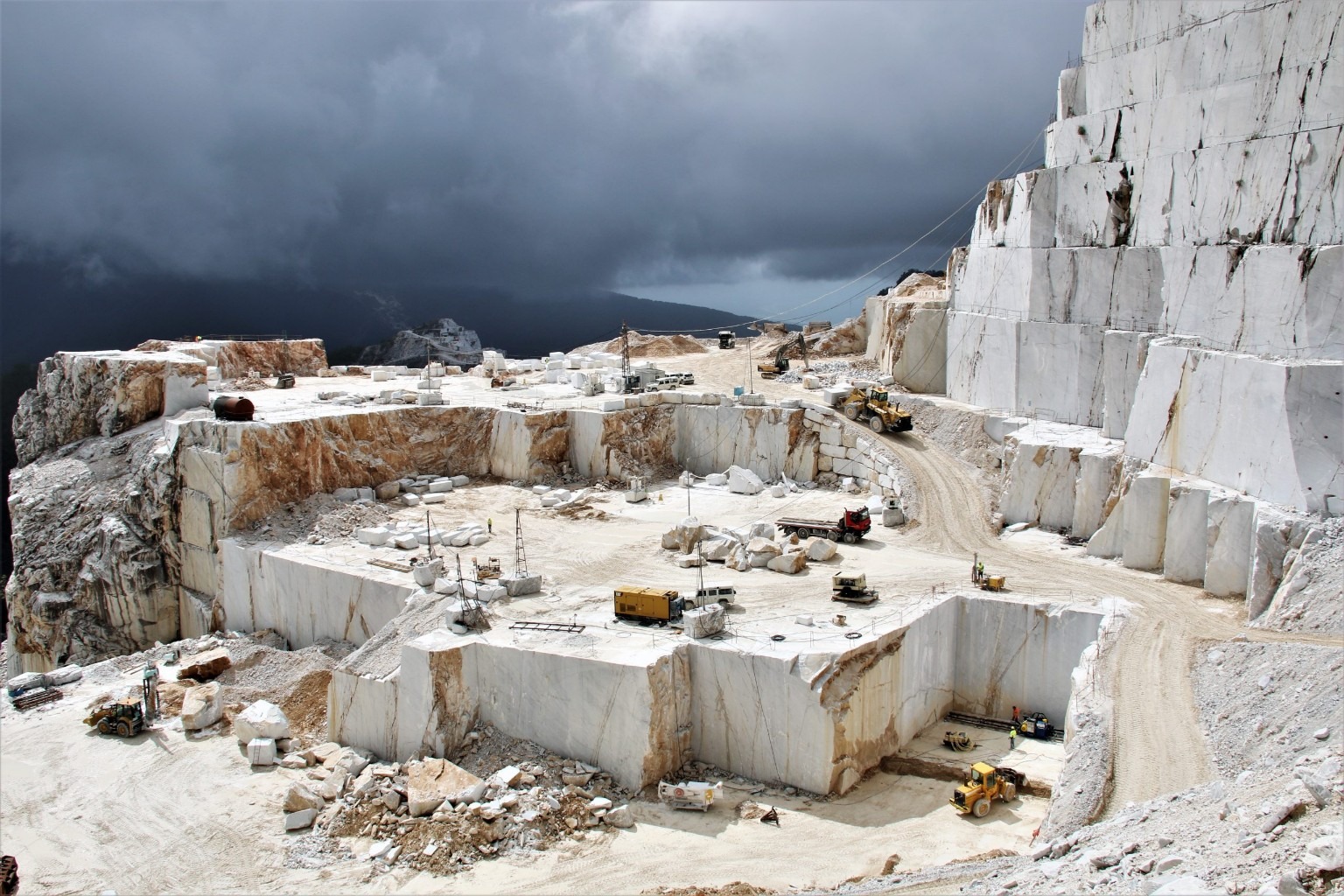White stone quarry beneath a cloudy sky