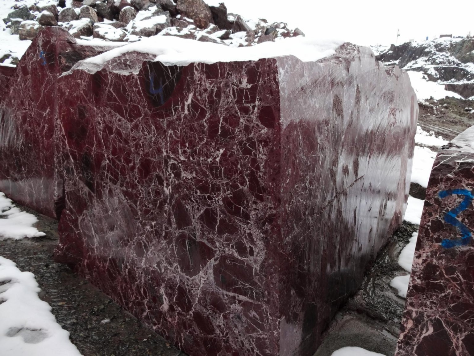 Deep red stone block at the quarry